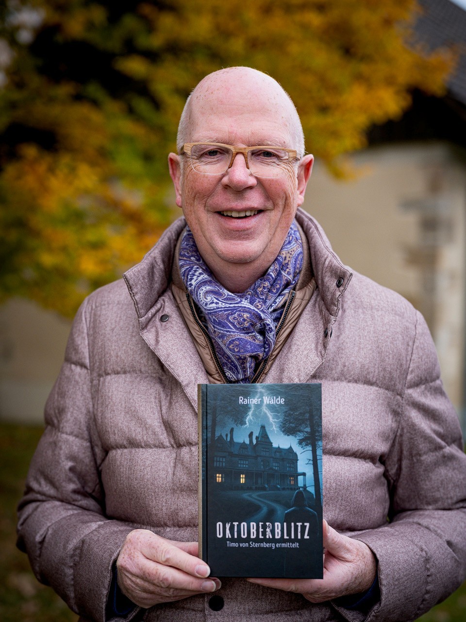 Portrait von Painer Wälde mit seinem Buch vor sich